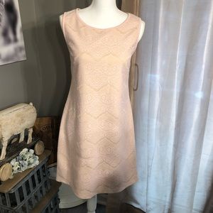 Fully lined, sleeveless lace dress.